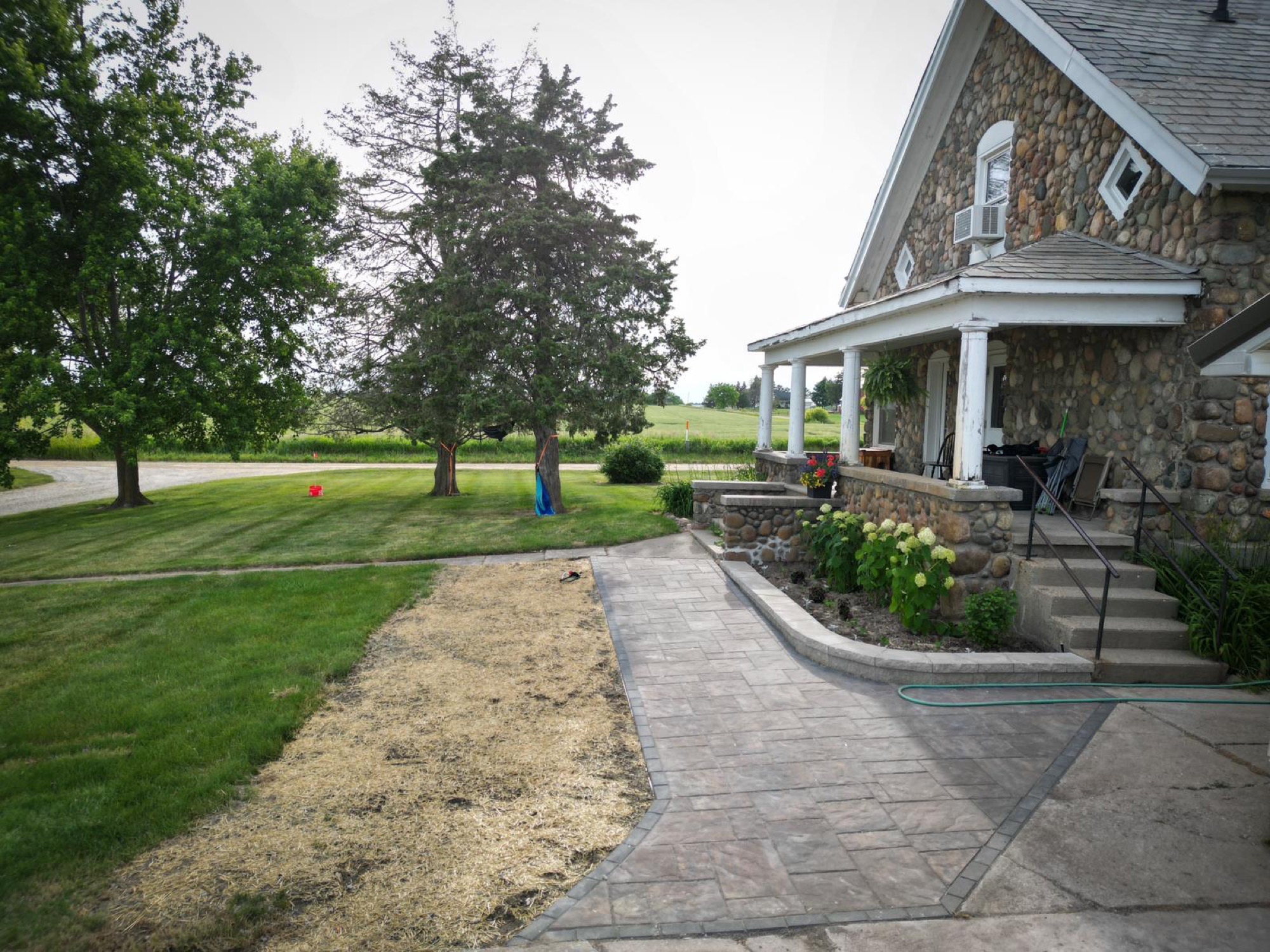 A paver walkway through a yard