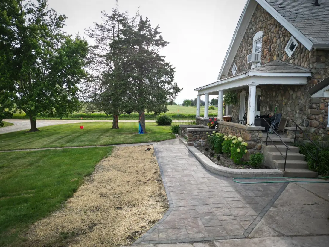 A paver walkway through a yard